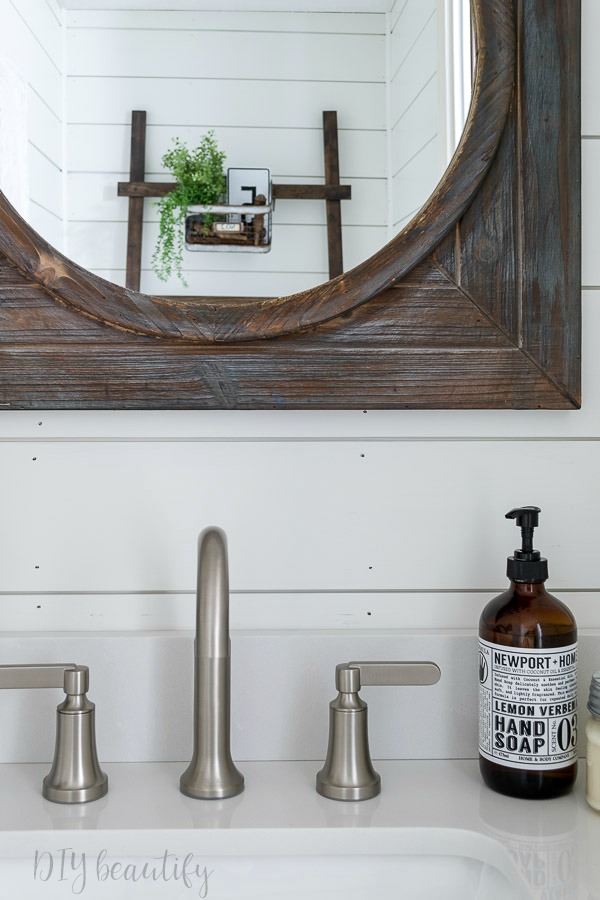 I'm revealing our small bathroom that we made over with products provided by Lowe's to add big farmhouse style! Come see it at DIY beautify! #farmhouse #bathroom #roommakeover #Lowes brushed nickel faucet